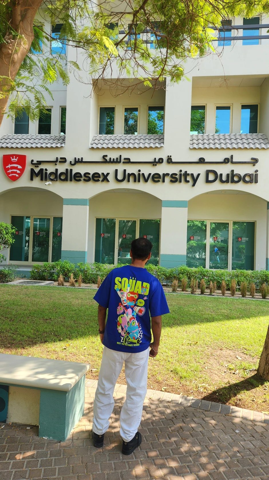 Amresh in front of the Middlesex University Dubai sign